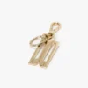 Llavero con charm en dorado Llavero con charm en dorado